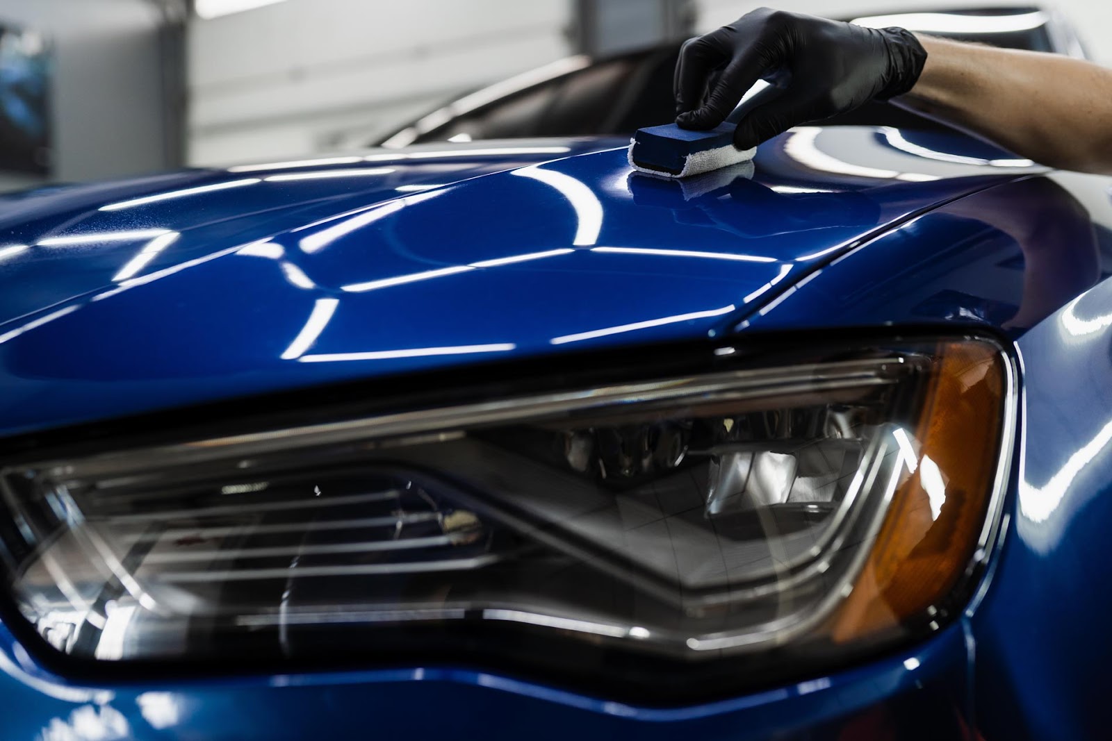 Man applying ceramic coating to the car's hood